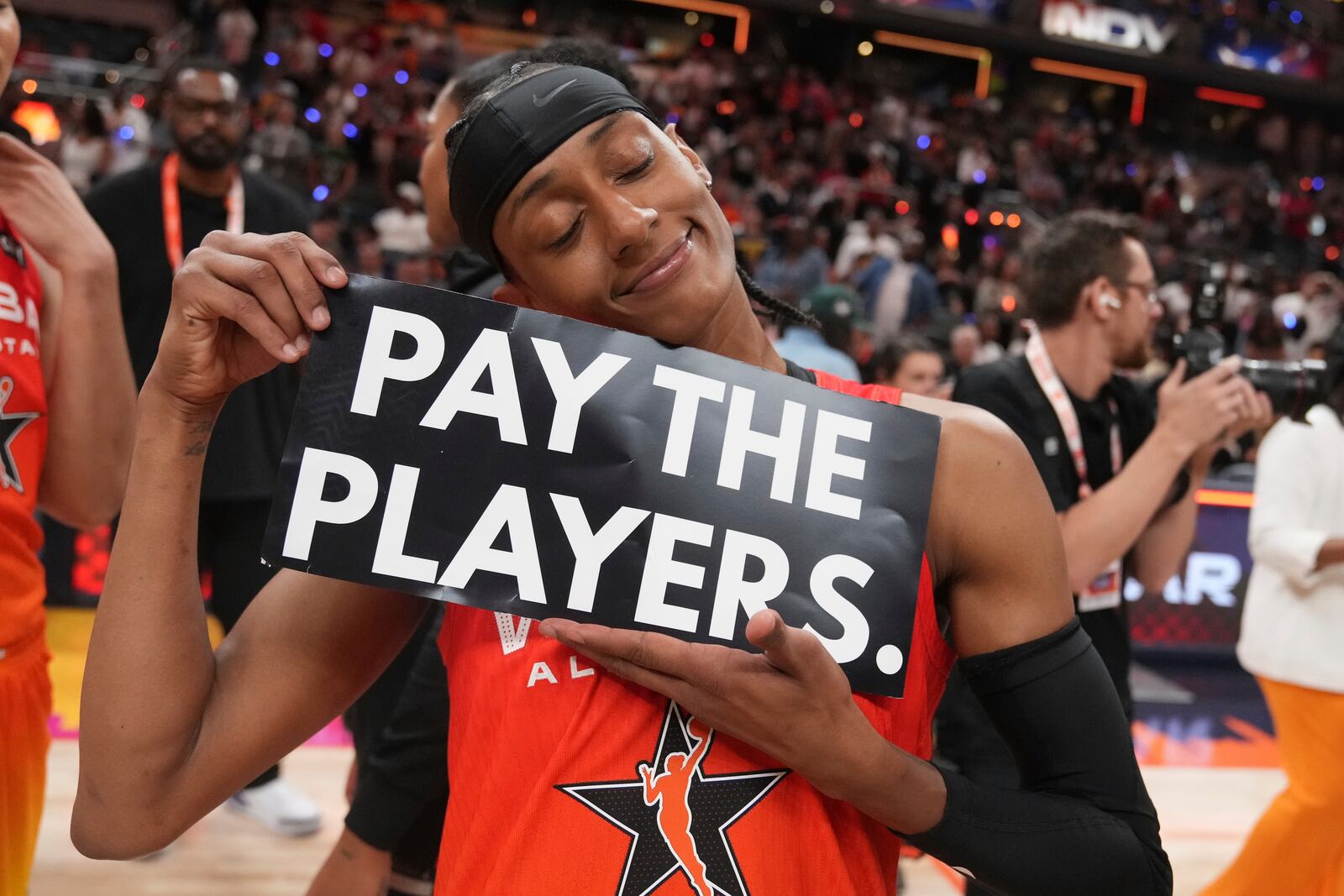 Washington Mystics' Brittney Sykes holds a sign following a WNBA All-Star basketball game against Team Collier, Saturday, July 19, 2025, in Indianapolis. (AP Photo/Michael Conroy)
