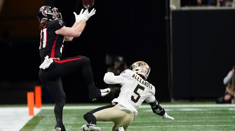 Atlanta Falcons tight end Hayden Hurst (81) makes the catch against New Orleans Saints middle linebacker Kwon Alexander (5) during the second half of an NFL football game, Sunday, Jan. 9, 2022, in Atlanta. (AP Photo/John Bazemore)