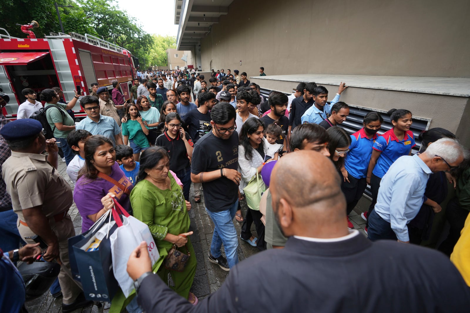 People are escorted to a safe place during a security mock drill at a mall in Ahmedabad, India, Wednesday, May 7, 2025, amid rising fears of wider conflict following India's strikes in Pakistan. (AP Photo/Ajit Solanki)