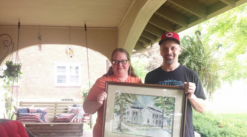 Jamie and Andy Seibert, who live on Yankee Road in Middletown, were presented a framed picture of their house that William “Bill” Rehse painted years ago. SUBMITTED PHOTO