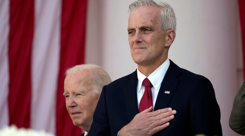 Veterans Affairs Secretary Denis McDonough watches as President Joe Biden arrives to speak at the National Veterans Day Observance at the Memorial Amphitheater at Arlington National Cemetery in Arlington, Va., Saturday, Nov. 11, 2023. (AP Photo/Andrew Harnik)
