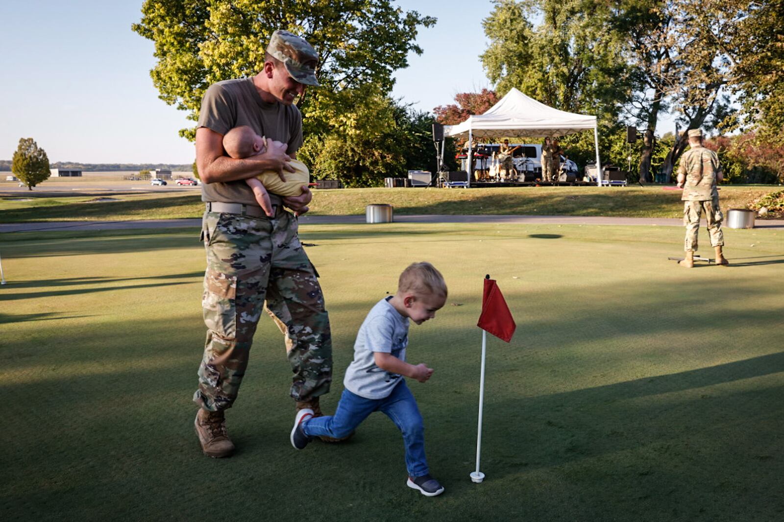 Derek Dennis celebrates the 96th anniversary of Wright Field with his son, Dawson and his daughter Adelynn on the golf course at Wright Patterson Air Force Base. Dennis is based at Wright-Patt and is part of the Air Force Materiel Command. JIM NOELKER / STAFF