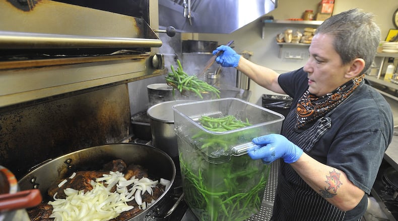 Restaurants in the Dayton region are continuing to support those facing food insecurity in the Miami Valley. Last week, Wheat Penny Oven & Bar distributed almost 500 meals in two days. Pictured is Liz Valenti, who owns the restaurant with Dave Rawson. FILE PHOTO