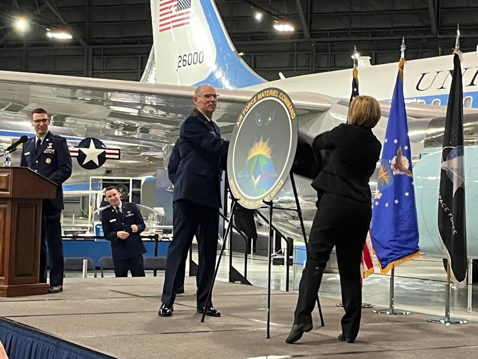 Gen. Duke Z. Richardson, left, and Amanda Gentry unveil new insignia for the Air Force Integrated Development Office Tuesday at the National Museum of the U.S. Air Force. THOMAS GNAU/STAFF