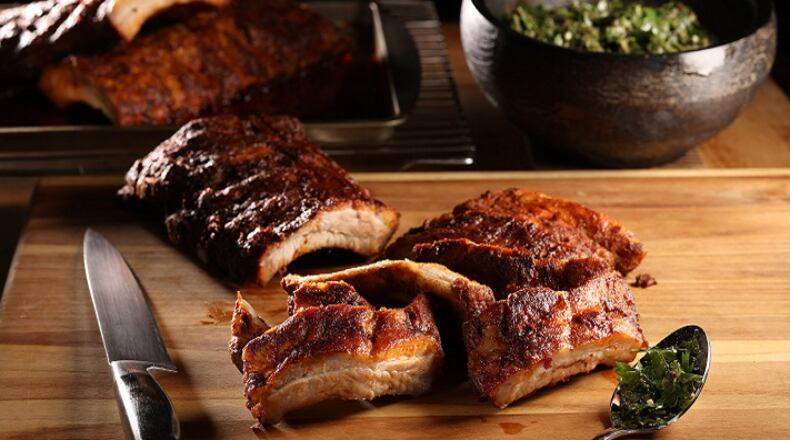 A Spanish-inspired marinade of paprika, pounded garlic and olive oil lends an earthy depth to ribs made in the oven. (Abel Uribe/Chicago Tribune/TNS)