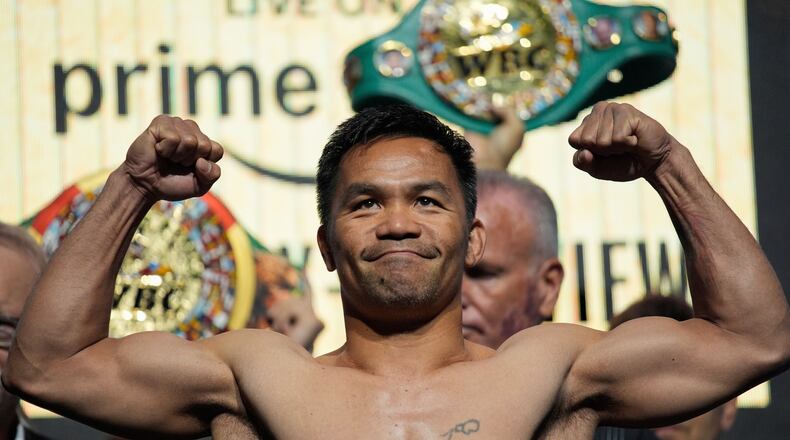 FILE - Manny Pacquiao poses on the scale during a ceremonial weigh in Friday, July 18, 2025, in Las Vegas. (AP Photo/John Locher, file)
