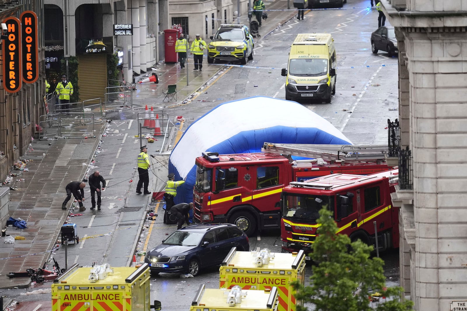 A tent is erected by police at the site of an incident on Water Street near the Liver Building in Liverpool after a car collided with pedestrians during the Premier League winners parade, in Liverpool, England, Monday May 26, 2025. (Danny Lawson/PA via AP)