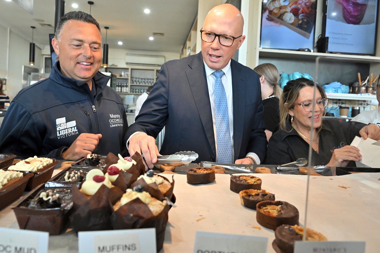 Leader of the Australian opposition Liberal party Peter Dutton, center, visits at a cake shop in Melbourne on Wednesday, April 30, 2025. (Mick Tsikas/AAP Image via AP)