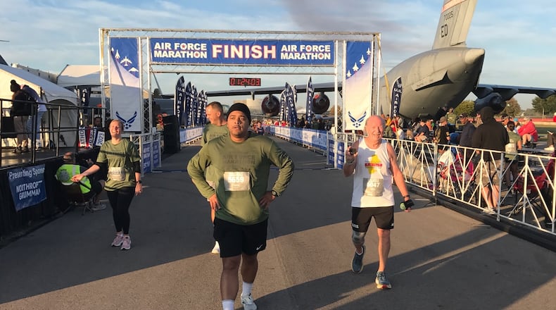 Mickey Lozan (right) finishing the 10 K race at last year’s Air Force Marathon. For the second year in a row he’d won the 80-and-up division of the race. Tom Archdeacon/CONTRIBUTED