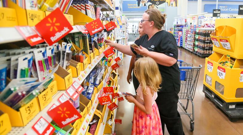 Brandy Cox shops for school supplies with her children Makaila Cox and Kara Rich, at the Walmart in West Chester, Wednesday, July 26, 2017. GREG LYNCH / STAFF