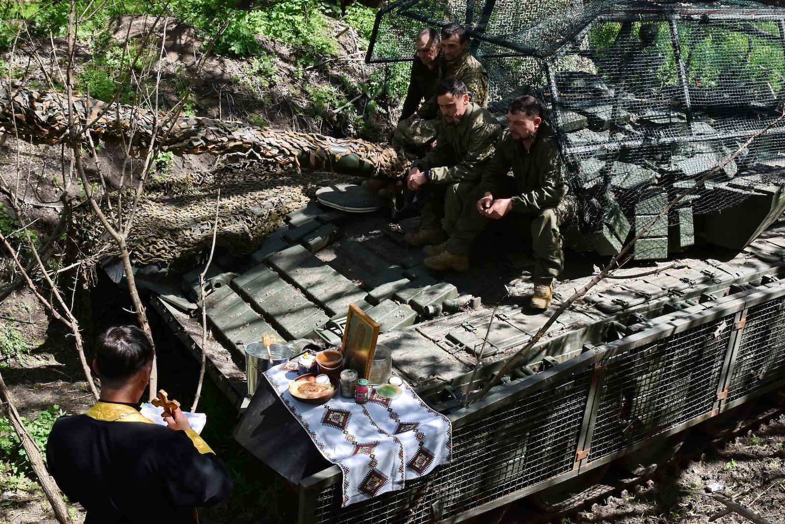 In this photo provided by Ukraine's 65th Mechanized Brigade press service, a chaplain conducts an Easter service for soldiers to mark Easter on the frontline in the Zaporizhzhia region, Ukraine, Sunday, April 20, 2025. (Andriy Andriyenko/Ukraine's 65th Mechanized Brigade via AP)