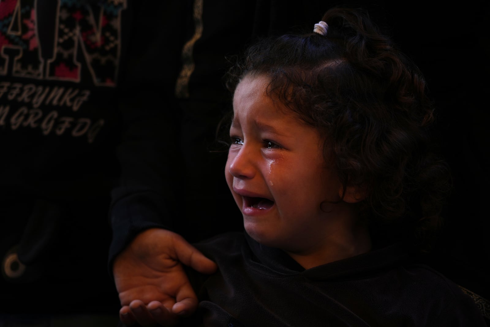 Mira, 4, cries during the funeral of her father, Hosam Wafi who, according to family members, was killed while heading to an aid distribution hub, in Khan Younis, southern Gaza Strip, Monday, June 2, 2025. (AP Photo/Abdel Kareem Hana)