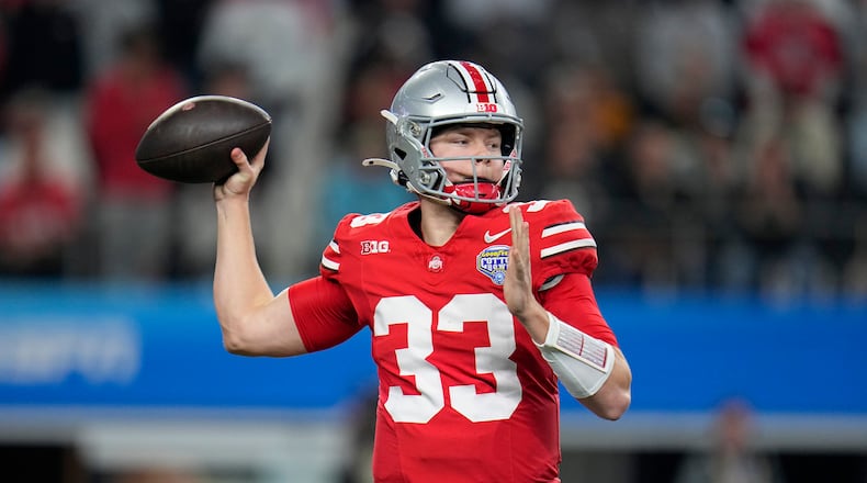 Ohio State quarterback Devin Brown throws a pass against Missouri during the first half of the Cotton Bowl NCAA college football game Friday, Dec. 29, 2023, in Arlington, Texas. (AP Photo/Julio Cortez)