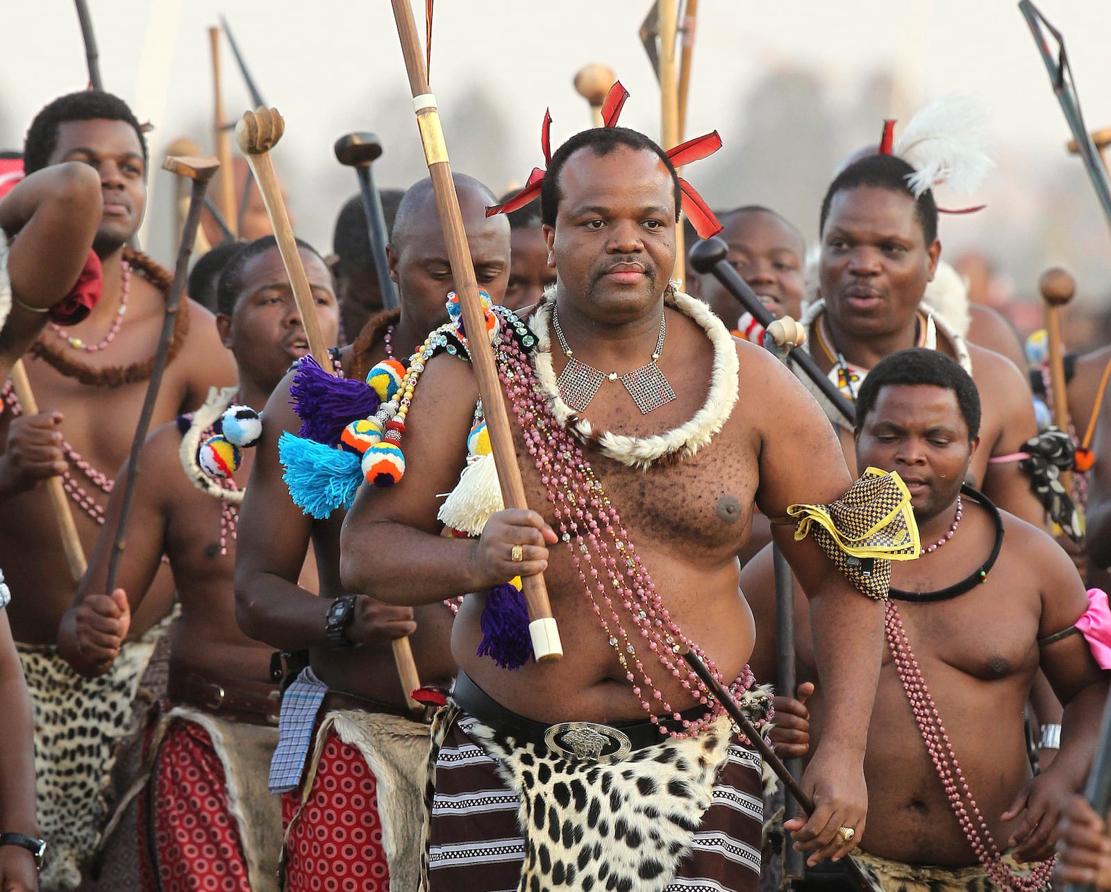 FILE - Eswatini's King, Mswati III, front, dances during a Reed Dance in Mbabane, Monday Sept. 3, 2012. (AP Photo/Themba Hadebe, File)