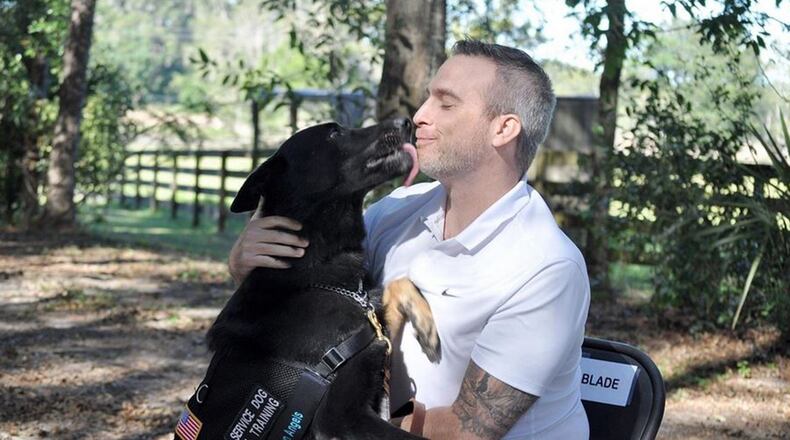 German shepherd Blade licks veteran Michael Clark s face in this undated photo. Clark was paired with his service dog by Guardian Angels Medical Service Dogs Inc. in October 2017 after suffering from a traumatic brain injury and post-traumatic stress disorder. PNC Financial Services is launching a Community Mutt Strut Oct. 19, 2019, at Eastwood MetroPark in Dayton to raise funds for underwriting the cost of 10 service dogs. CONTRIBUTED PHOTO
