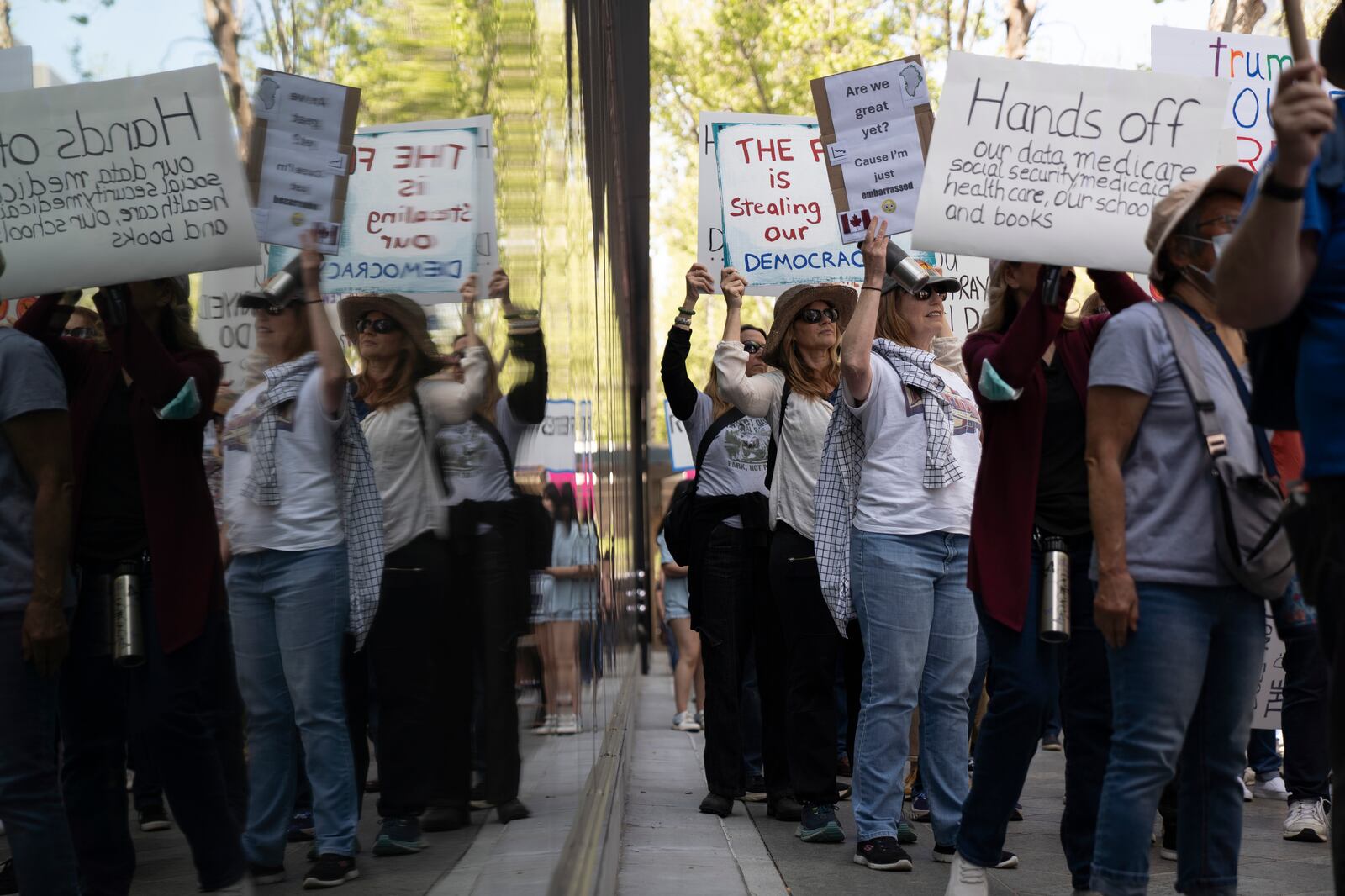 Demonstrators rally against President Donald Trump and Tesla CEO Elon Musk in San Jose, Calif., on Saturday, April 5, 2025, as part of the nationwide "Hands Off!" protest. (AP Photo/Emily Steinberger)