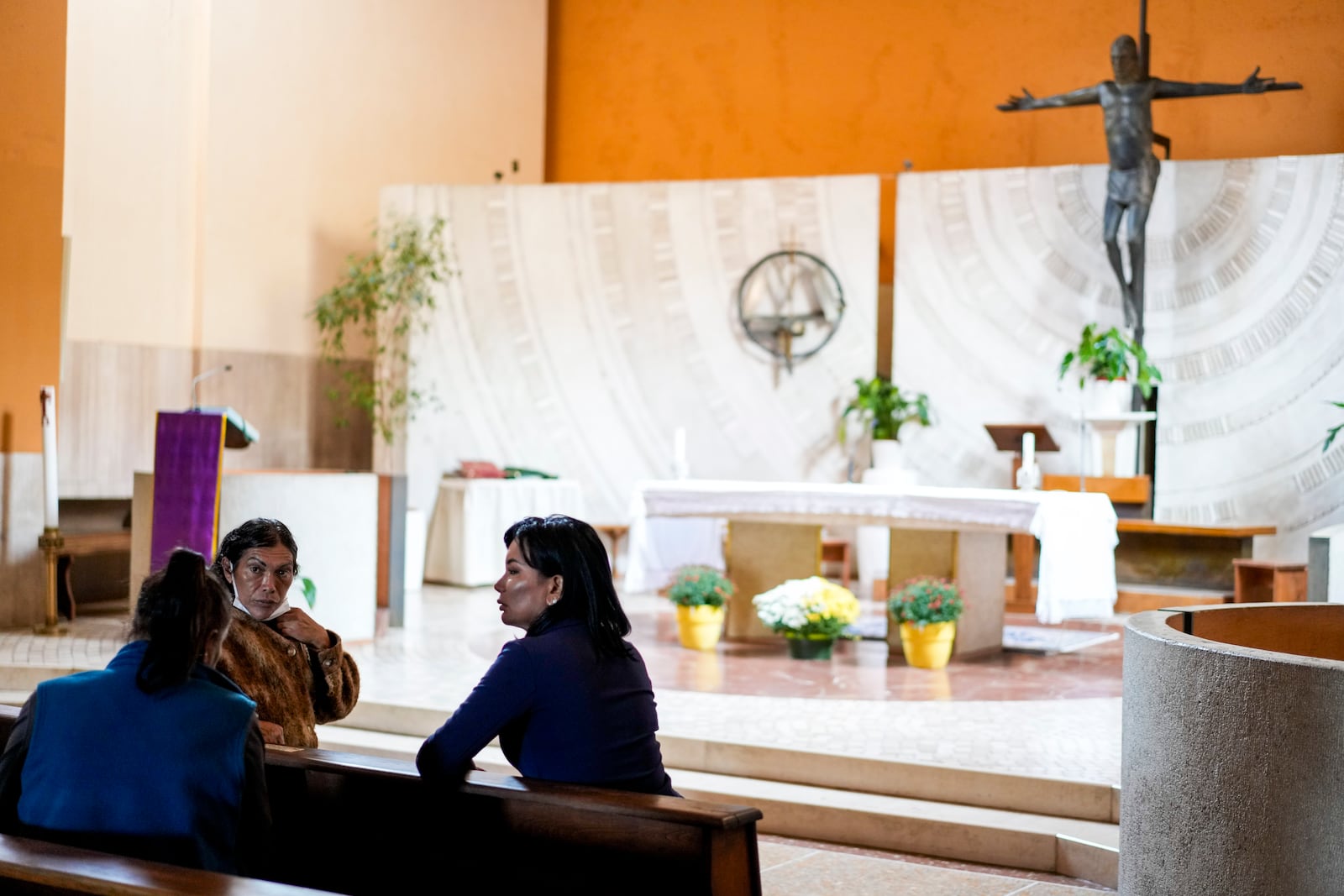 FILE - Transgender women, from left, Claudia Vittoria Salas, Andrea Paola Torres Lopez and Carla Segovia speak as they sit in the Beata Vergine Immacolata church in Torvaianica, Italy, on Nov. 16, 2023. (AP Photo/Andrew Medichini, File)