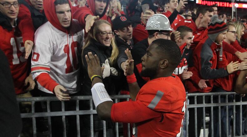 Ohio State’s J.T. Barrett celebrates with fans after a victory over Nebraska on Saturday, Nov. 5, 2016, at Ohio Stadium in Columbus. David Jablonski/Staff