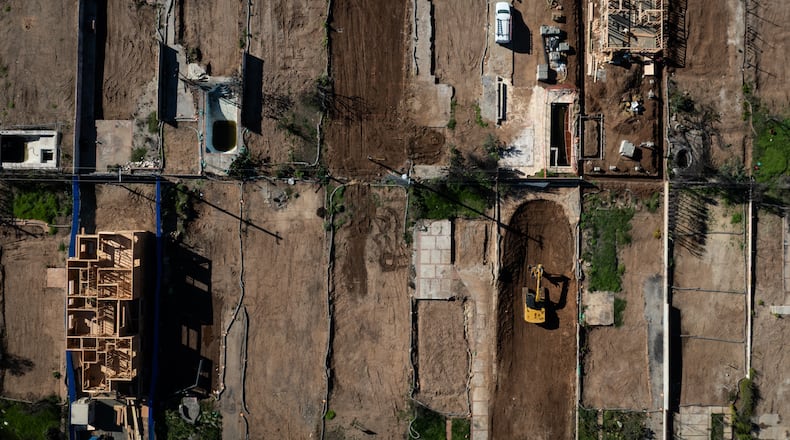 FILE - An aerial view shows houses being rebuilt on cleared lots months after the Palisades Fire, Dec. 5, 2025, in the Pacific Palisades neighborhood of Los Angeles. (AP Photo/Jae C. Hong, File)