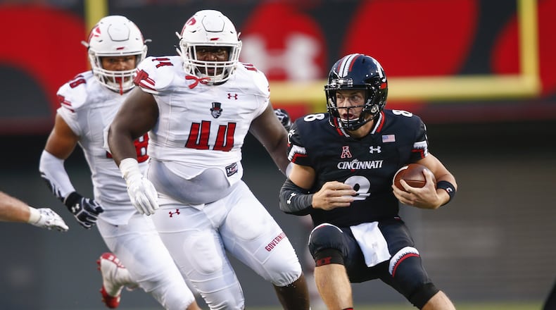 CINCINNATI, OH - AUGUST 31: Hayden Moore #8 of the Cincinnati Bearcats runs the ball as Pat Walker #44 of the Austin Peay Governors pursues at Nippert Stadium on August 31, 2017 in Cincinnati, Ohio. (Photo by Michael Hickey/Getty Images)