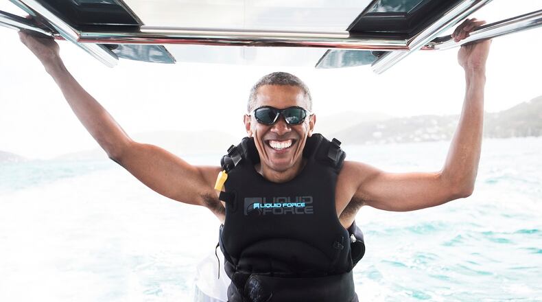 In this recent but undated photo made available by Virgin.com, former U.S President Barack Obama prepares to kitesurf during his stay on Moskito Island, British Virgin Islands. The former president and his wife stayed on Mosikto Island owned by Richard Branson, founder of the Virgin Group, after he finished his second term as President and left the White House. (Jack Brockway/Virgin.com via AP)