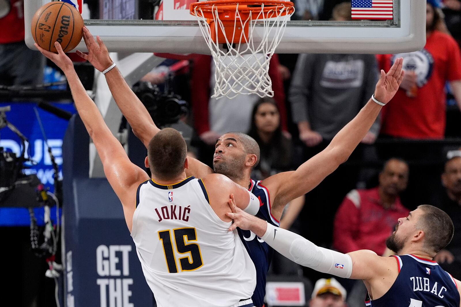 Denver Nuggets center Nikola Jokic, left, shoots as Los Angeles Clippers forward Nicolas Batum defends during the first half in Game 4 of an NBA basketball first-round playoff series Saturday, April 26, 2025, in Inglewood, Calif. (AP Photo/Mark J. Terrill)