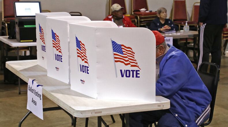 A man casts his vote at the Springfield election poll in the VFW 1031 Tuesday. BILL LACKEY/STAFF