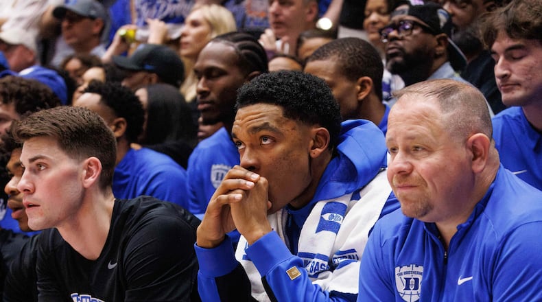 Duke's Caleb Foster sits on the bench wearing a boot after suffering an injury during the first half of an NCAA college basketball game against North Carolina in Durham, N.C., Saturday, March 7, 2026. (AP Photo/Ben McKeown)
