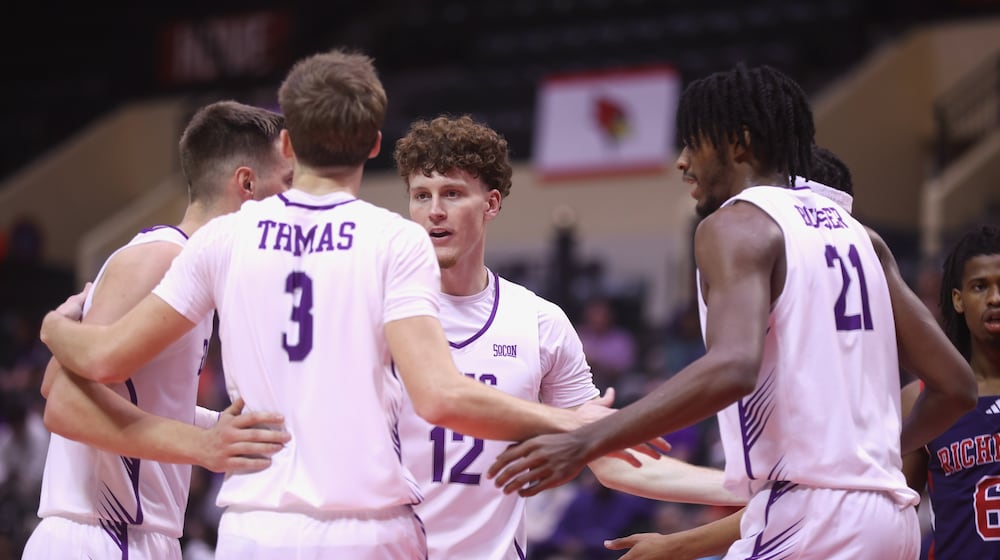 Centerville graduate Tom House, a senior at Furman, huddles with his teammates during a game against Richmond in the first round of the ESPN Events Invitational on Thursday, Nov. 27, 2025, at the State Farm Field House in Kissimmee, Fla. David Jablonski/Staff