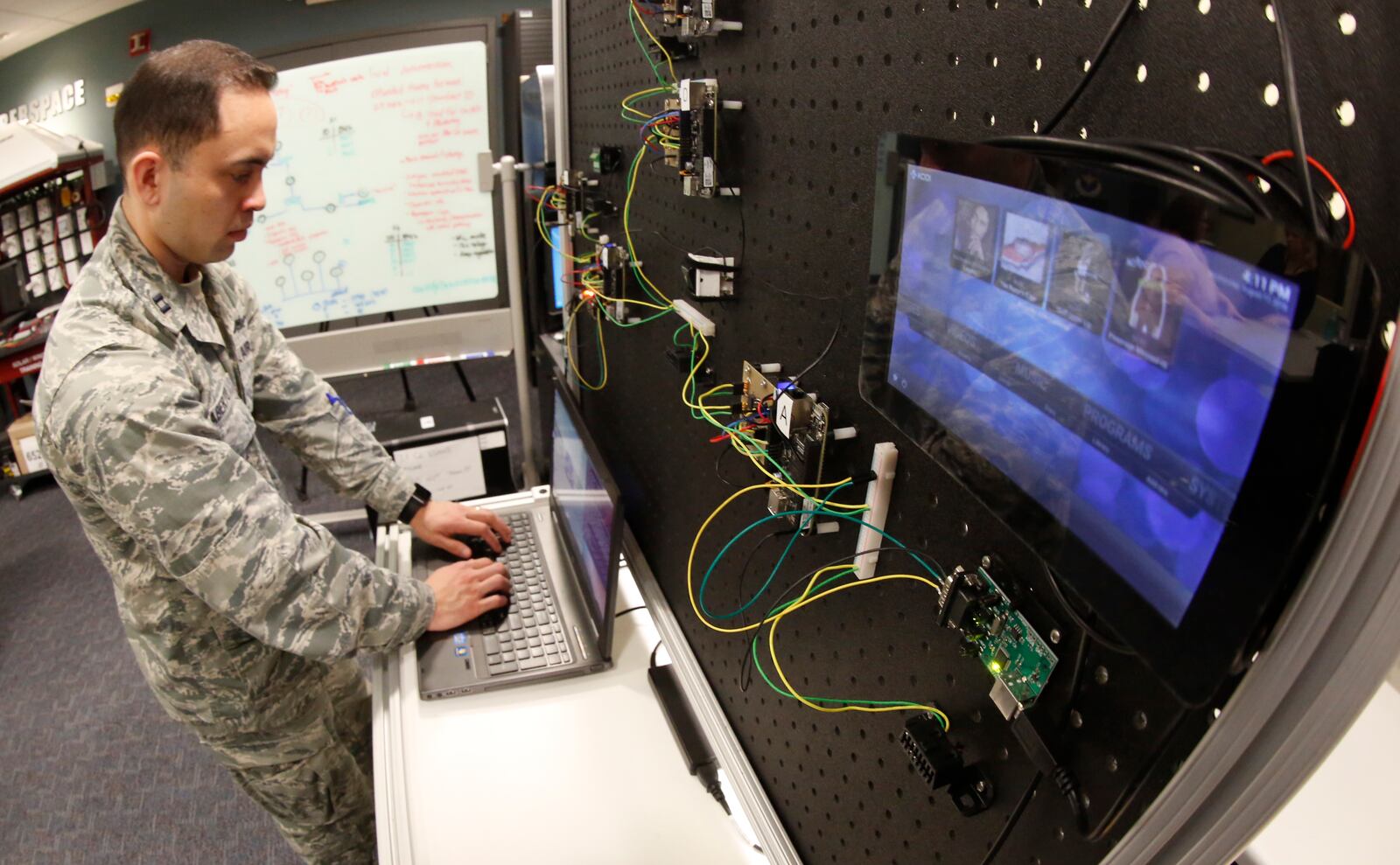Graduate student Capt. Eddie Caberto is studying ways to thwart hacking of vehicle controls with an automobile simulator at the Center for Cyber Research at the Air Force Institute of Technology, Wright-Patterson Air Force Base.  TY GREENLEES / STAFF