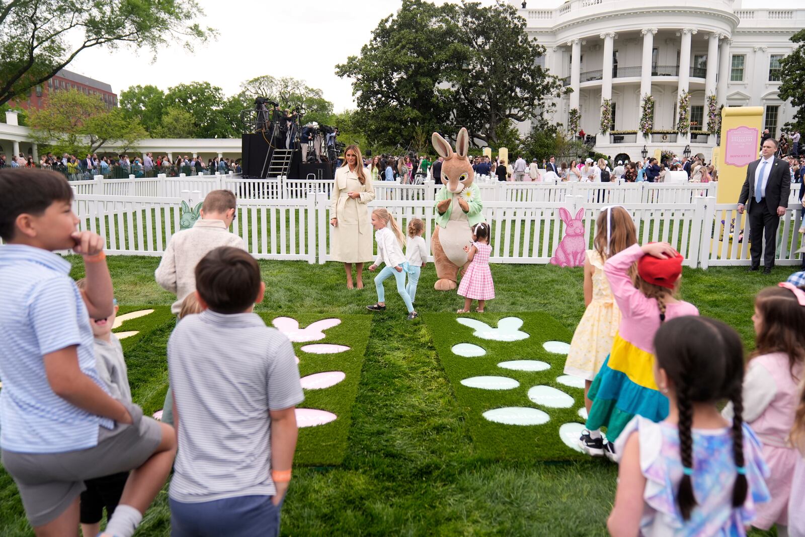 First lady Melania Trump talks with children as they play a game of hopscotch during the White House Easter Egg Roll on the South Lawn of the White House, Monday, April 21, 2025, in Washington. (AP Photo/Mark Schiefelbein)