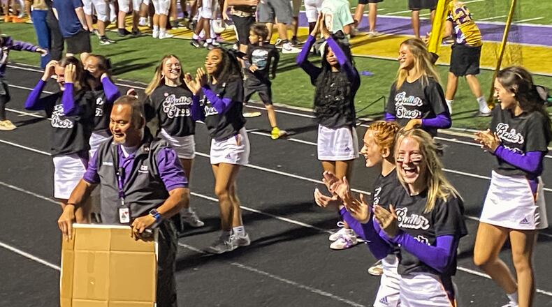 The student section cheered on school safety officer Settich as he encouraged school spirit during a recent Friday night football game at Vandalia Butler. Courtesy of Vandalia-Butler.