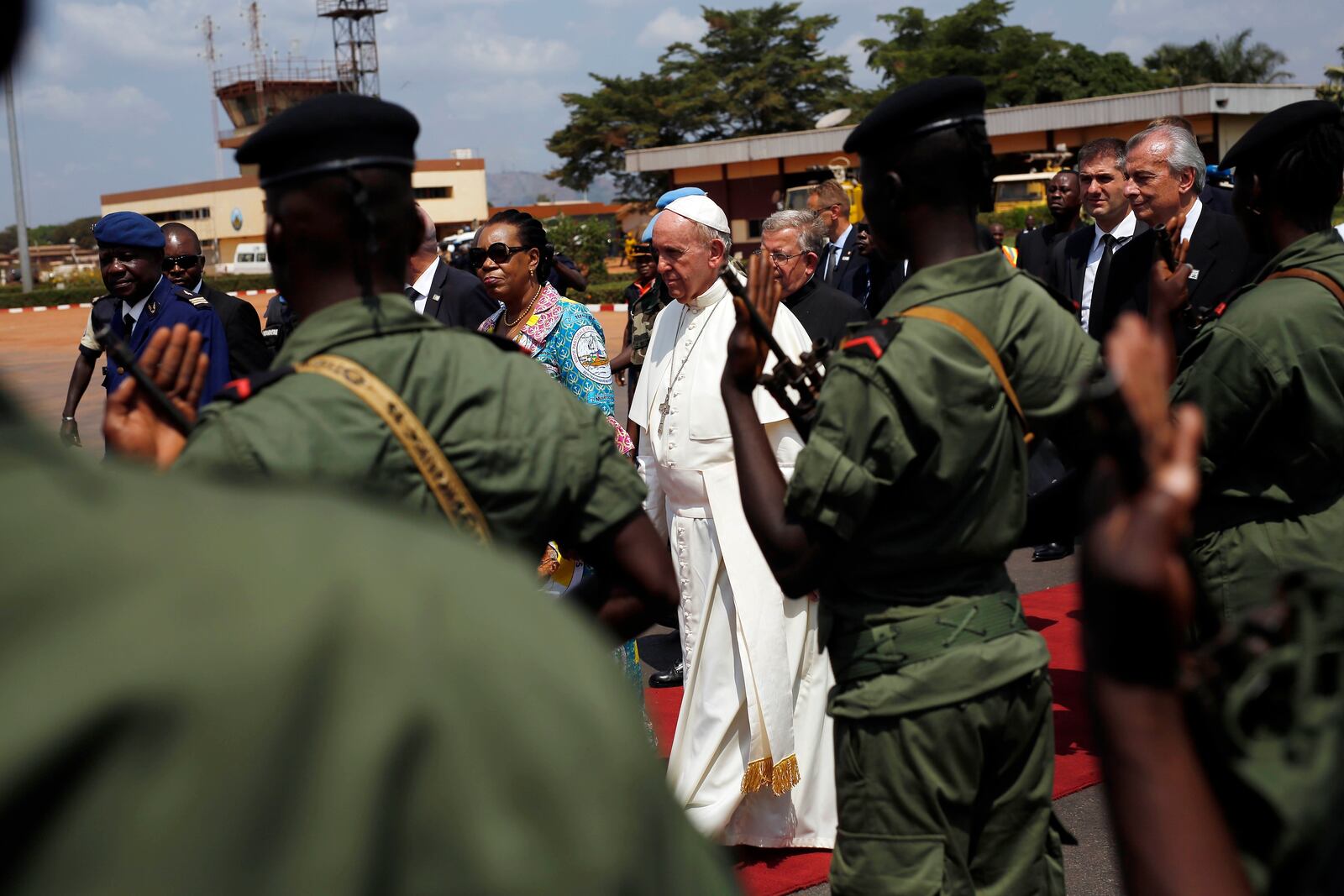 FILE - Pope Francis and Catherine Samba-Panza, interim President of the Central African Republic, walk past the honor guard at the international airport in Bangui, Central African Republic, Nov. 30, 2015. (AP Photo/Jerome Delay, File)