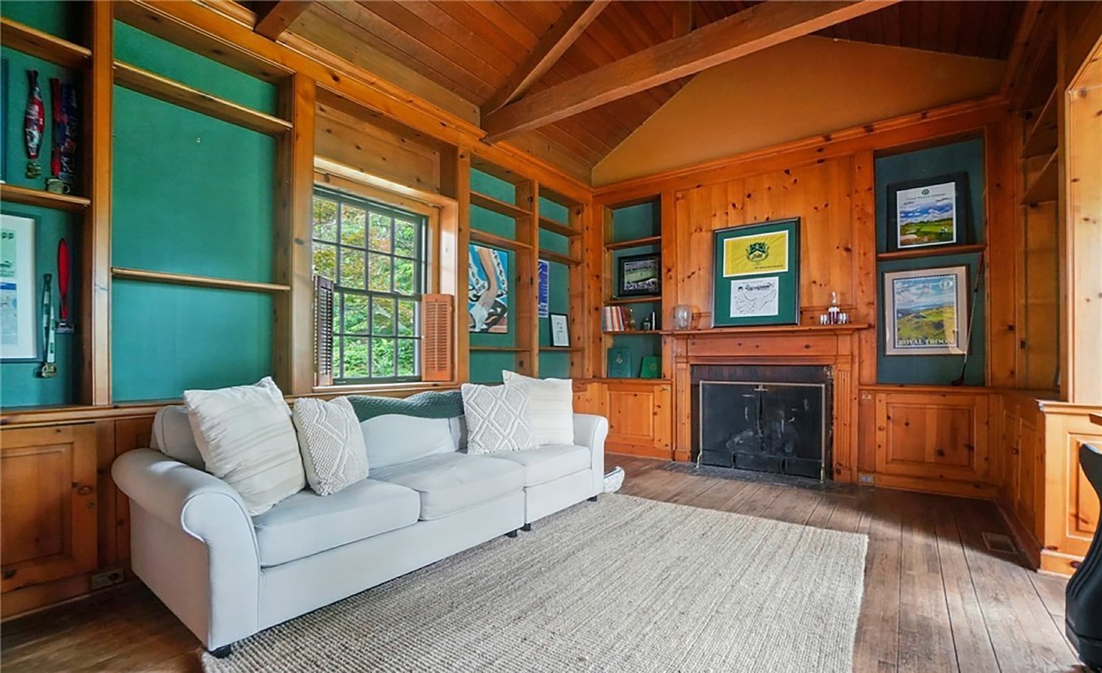 The sunken family room/office has a fireplace, wood paneled walls and beamed vaulted ceilings. CONTRIBUTED