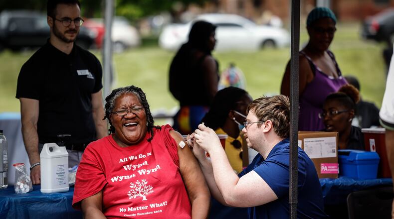 Marlene Alexander, a resident of Desoto Bass, gets her COVID-19 vaccine from the ZIKS Pharmacy booth at a community fair held June 23, 2021.