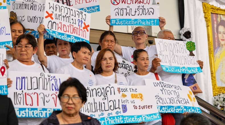 Plaintiffs and supporters in a case against Thailand's largest gold mine stand in front of the Bangkok Civil Court in Bangkok, Thailand, on Tuesday, March 24, 2026. (AP Photo/Anton L. Delgado)