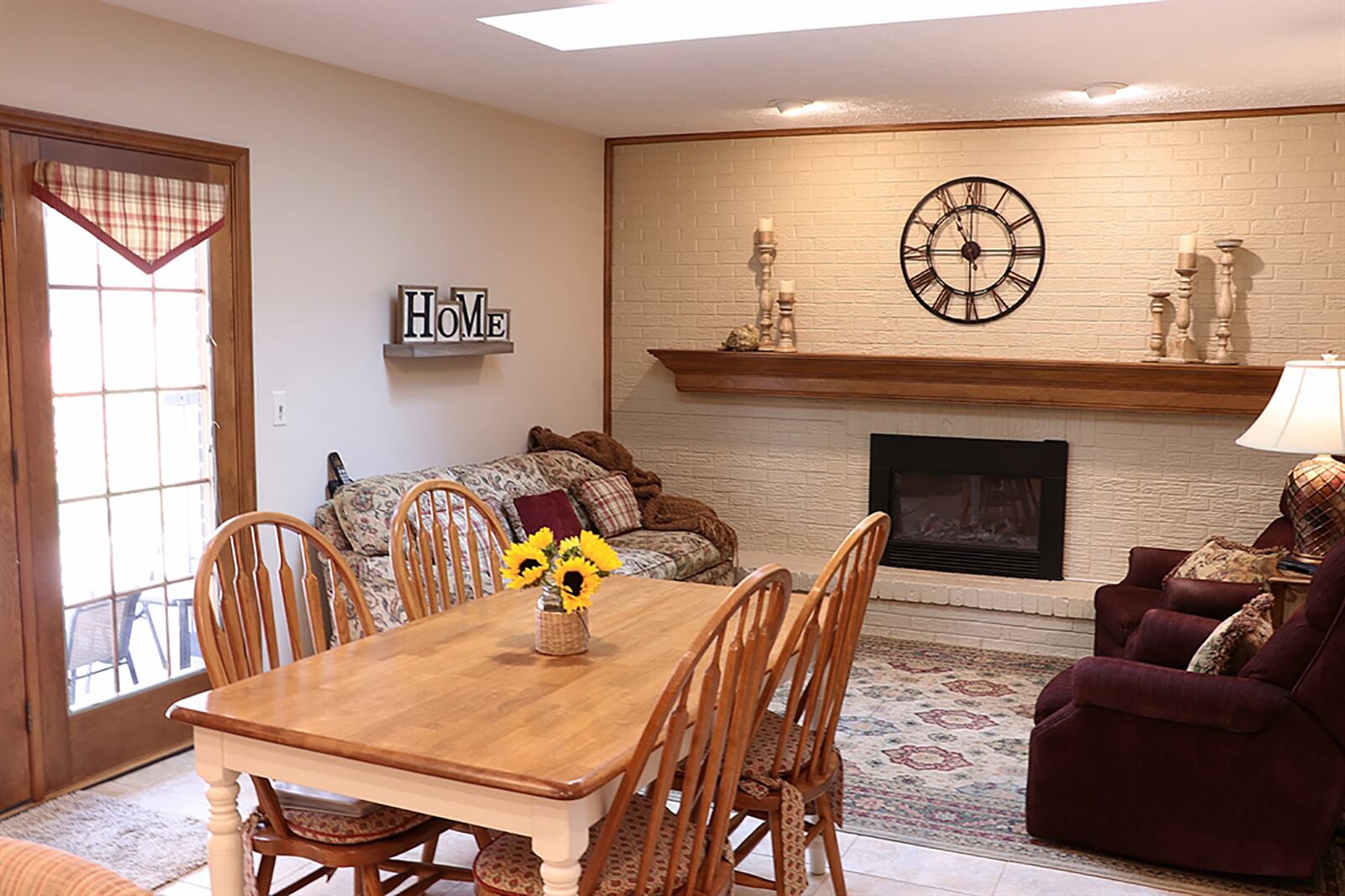 Ceramic-tile flooring fills the kitchen and extends into the breakfast room and hearth room. A painted brick wall surrounds the fireplace, which has a custom wood mantel. CONTRIBUTED PHOTO BY KATHY TYLER