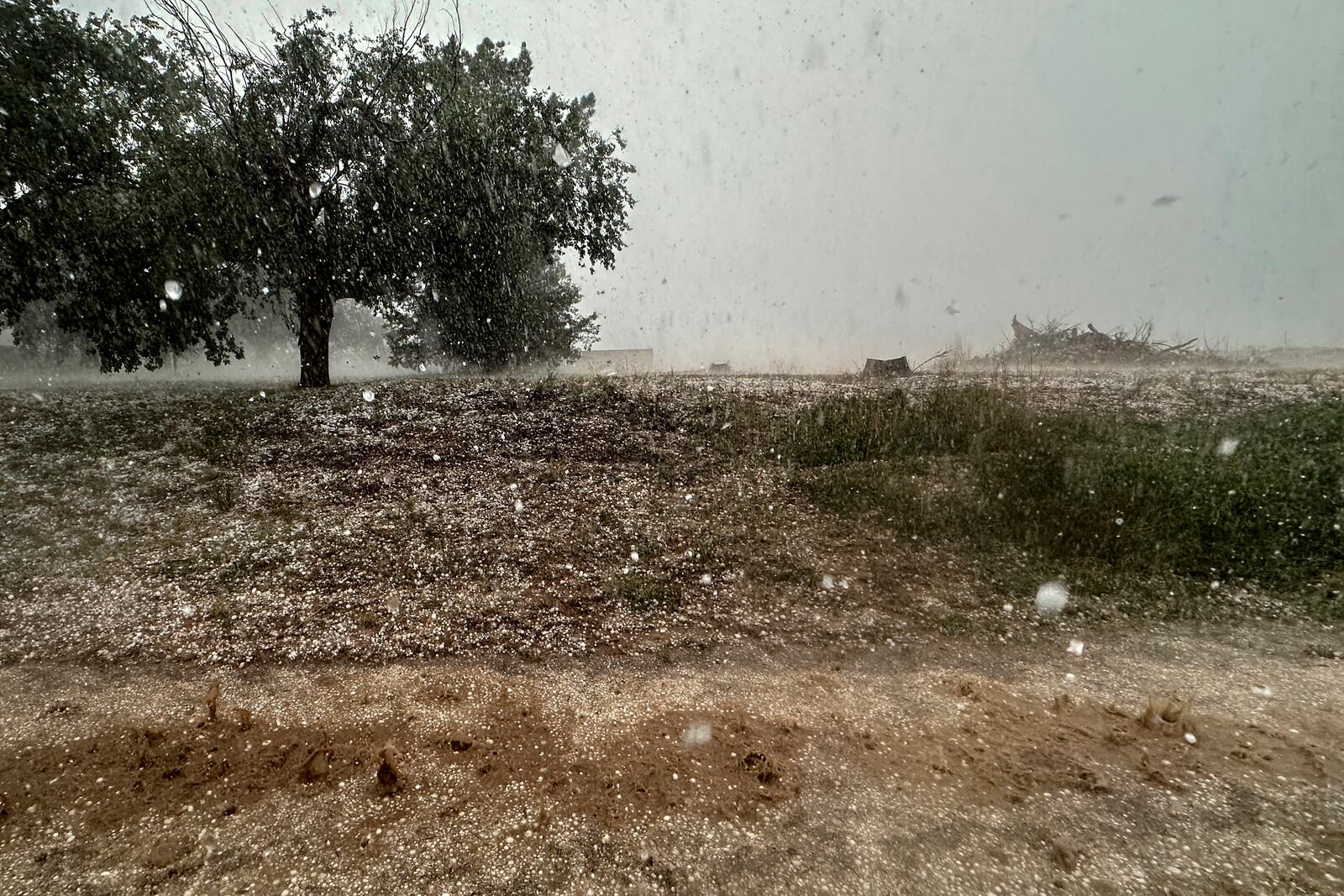 A hailstorm is visible from Northern Illinois University's Husky Hail Hunter vehicle during a Project ICECHIP operation Friday, June 6, 2025, in Levelland, Texas. (AP Photo/Carolyn Kaster)