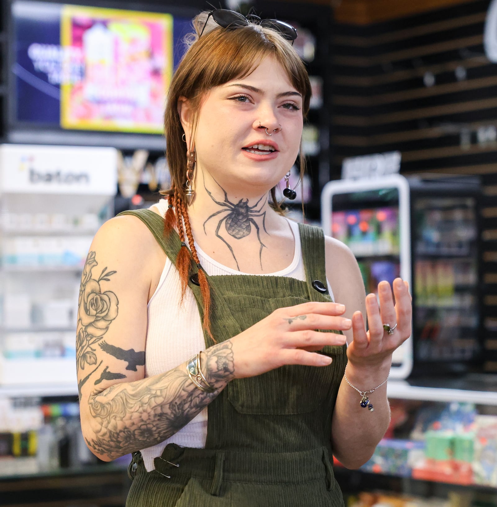 Jo Day, an assistant at VIP Smoke Shop in Trotwood, talks in the store on Tuesday, Oct. 14. Day helped remove products ahead of Gov. Mike DeWine's 90-day ban on intoxicating hemp-derived THC products, which went into effect on Tuesday. BRYANT BILLING / STAFF