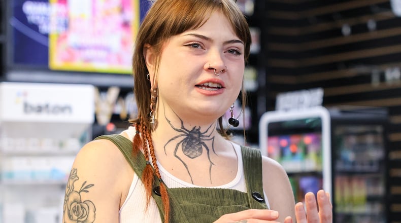 Jo Day, an assistant at VIP Smoke Shop in Trotwood, talks in the store on Tuesday, Oct. 14. Day helped remove products ahead of Gov. Mike DeWine's 90-day ban on intoxicating hemp-derived THC products, which went into effect on Tuesday. BRYANT BILLING / STAFF