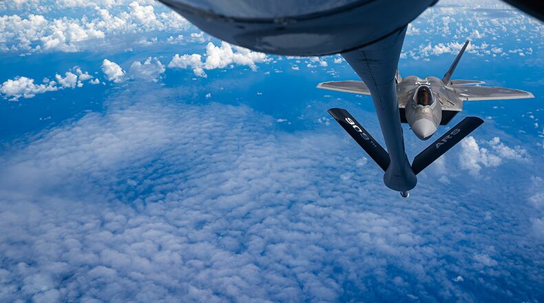 A 199th Fighter Squadron F-22A Raptor approaches a 909th Air Refueling Squadron KC-135 Stratotanker over the East China Sea on June 8. The 199th FS conducted agile combat employment operation in the Pacific to strengthen the readiness and interoperability needed to defend Japan and ensure a free and open Indo-Pacific. U.S. AIR FORCE PHOTO/SENIOR AIRMAN STEPHEN PULTER