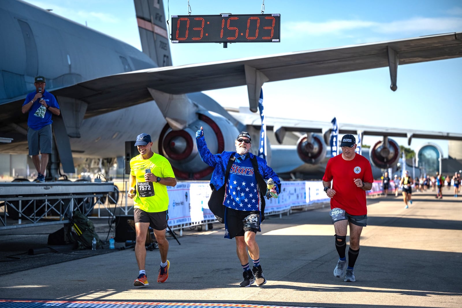 Stars runner Gary Moroney, a U.S. Air Force veteran, wearing a sparkling blue tuxedo jacket with tails, crosses the finish line last year. He also ran the 5K and 10K last year.  CONTRIBUTED PHOTO
