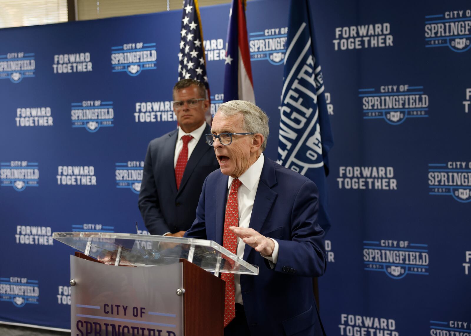 Gov. Mike DeWine speaks at a press conference near Ohio Department of Public Safety director Andy Wilson on Monday, May 19, 2025, at Springfield City Hall. JOSEPH COOKE/STAFF
