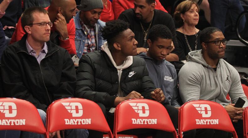 Belmont’s Shawn Phillips, second from left, sits behind the Dayton bench during a game against Davidson on Friday, Feb. 28, 2020, at UD Arena. David Jablonski/Staff