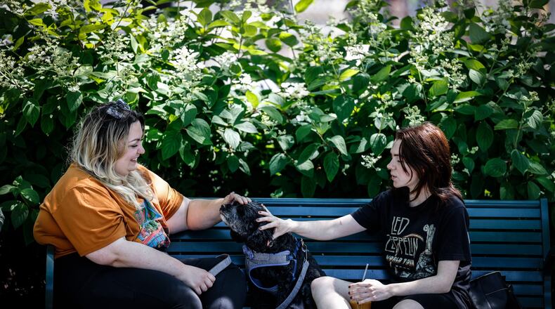 Emma Mills, left and Drake Haworth along with their dog, Salem, enjoy a warm Spring day at Riverscape Metro Park. JIM NOELKER/STAFF