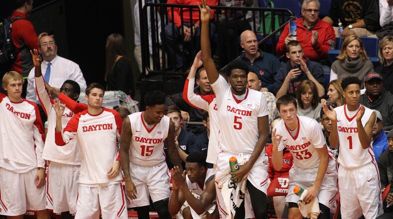 Dayton players on the bench celebrate after a 3-pointer against Southeast Missouri State on Friday, Nov. 13, 2015, at UD Arena in Dayton. David Jablonski/Staff