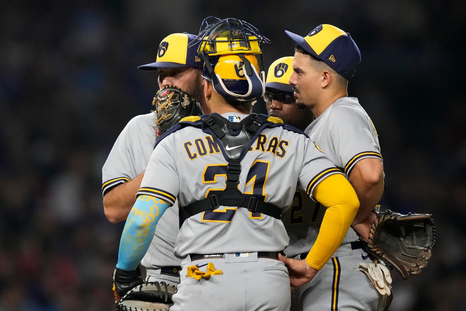 Milwaukee Brewers starting pitcher Wade Miley, left, talks with catcher William Contreras, shortstop Willy Adames, right, and second baseman Andruw Monasterio during the sixth inning of a baseball game against the Chicago Cubs Monday, Aug. 28, 2023, in Chicago. (AP Photo/Charles Rex Arbogast)