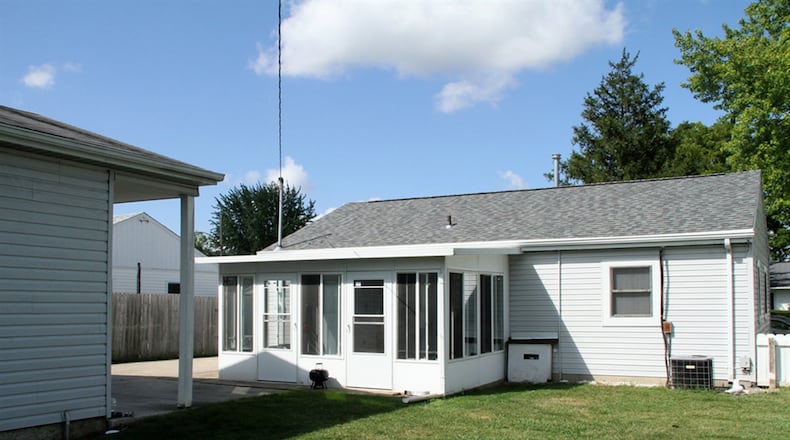 A single door off the kitchen opens out to the 3-season Florida room, which has lockable windows and 2 screen doors that open to the semi-fenced back yard and patio area. There is an oversized, 2-car, detached garage.