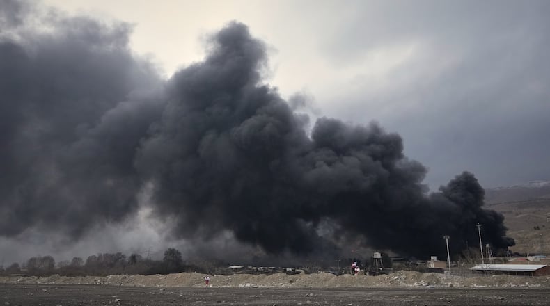 A thick plume of smoke rises from an oil storage facility hit by a U.S.-Israeli strike late Saturday in Tehran, Iran, Sunday, March 8, 2026. (AP Photo/Vahid Salemi)
