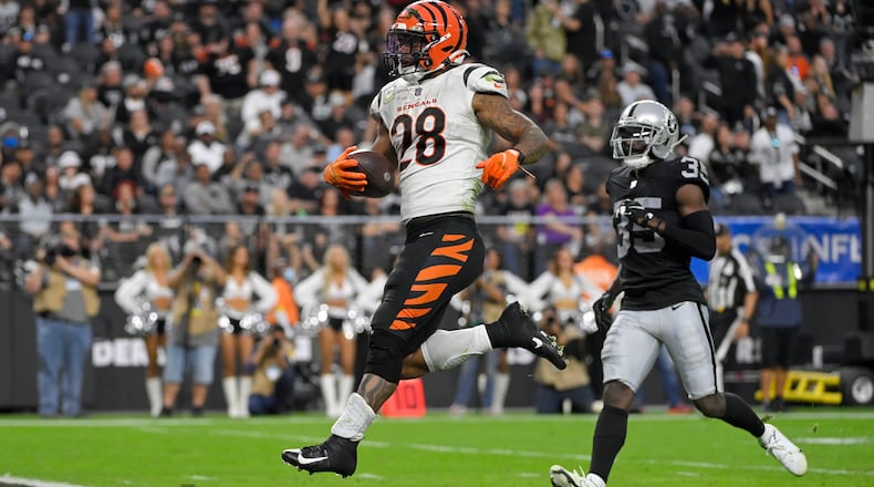 Cincinnati Bengals running back Joe Mixon (28) scores a touchdown against the Las Vegas Raiders during the second half of an NFL football game, Sunday, Nov. 21, 2021, in Las Vegas. (AP Photo/David Becker)